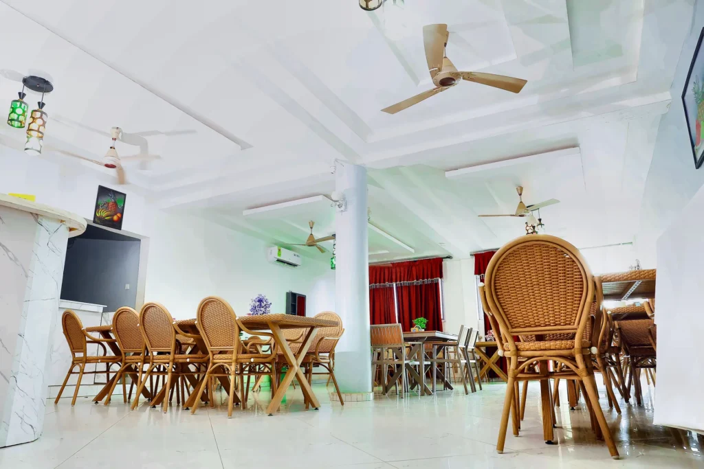 Open-plan restaurant seating with ceiling fans at Leisure Cozy Hotel, Hohoe